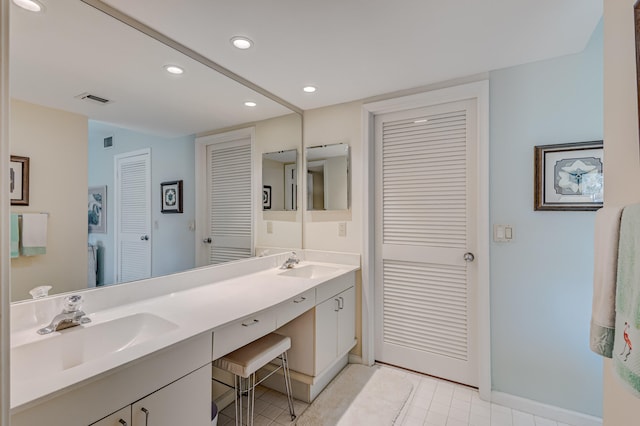 bathroom featuring double vanity and tile flooring