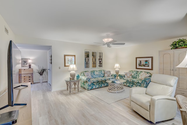 living room with ceiling fan and light hardwood / wood-style floors