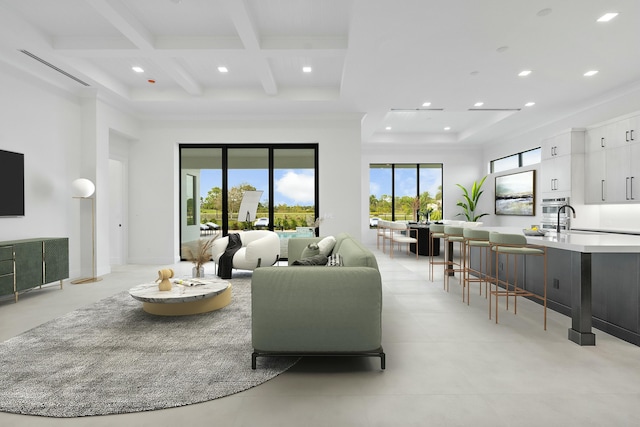 living room with beam ceiling, sink, and coffered ceiling