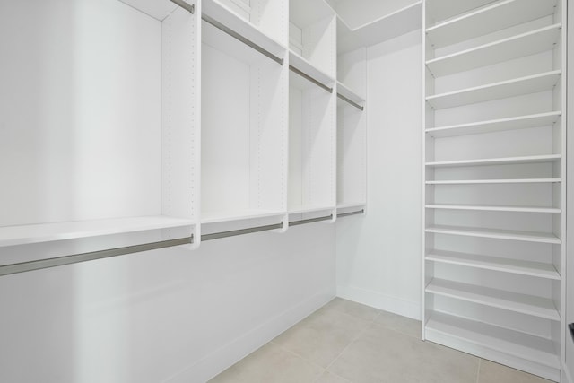 walk in closet featuring light tile patterned flooring