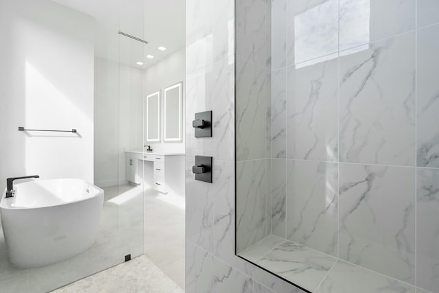 bathroom featuring a washtub and vanity