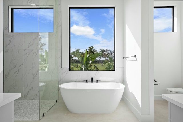 bathroom with tile patterned flooring, vanity, and plus walk in shower