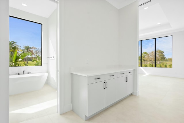 hallway with a tray ceiling