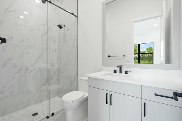 bathroom with an enclosed shower, vanity, and toilet