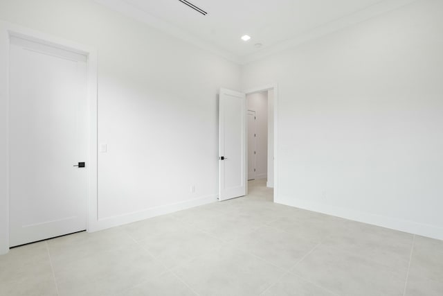 spare room with light tile patterned floors and ornamental molding