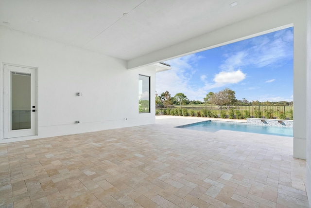 view of swimming pool with pool water feature and a patio area