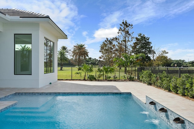 view of swimming pool with pool water feature and a patio area