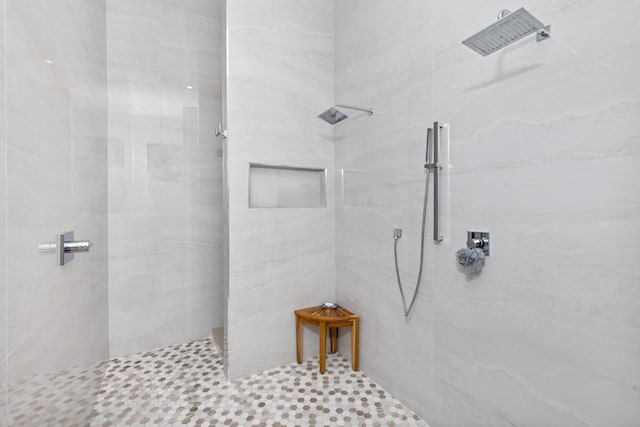 bathroom with a tile shower