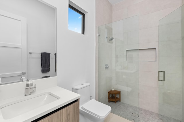 bathroom with tile patterned flooring, vanity, toilet, and walk in shower