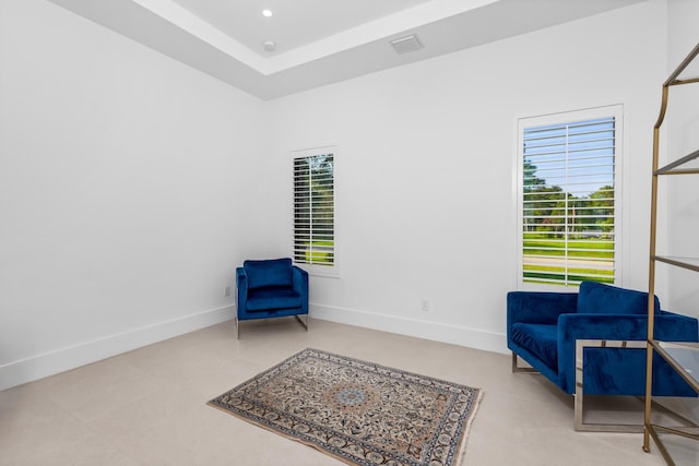 sitting room with a raised ceiling