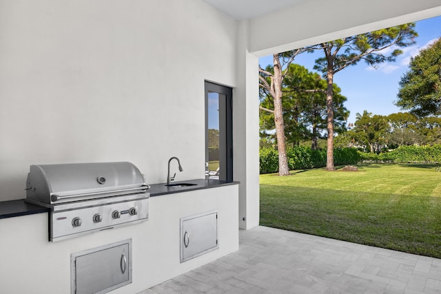 view of patio / terrace with area for grilling, sink, and exterior kitchen