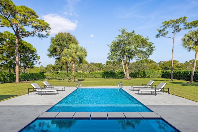 view of pool featuring a yard and a patio