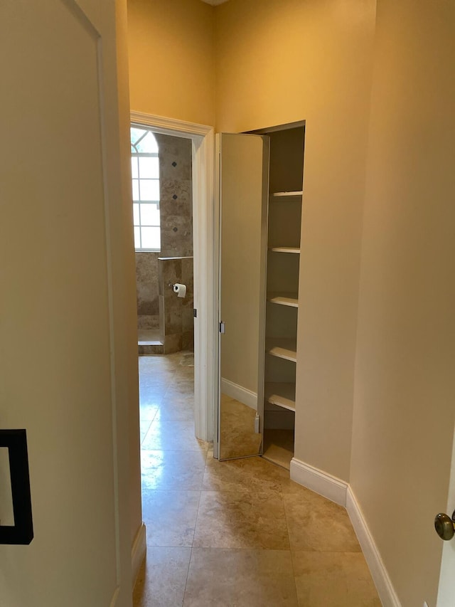 hallway featuring light tile patterned floors