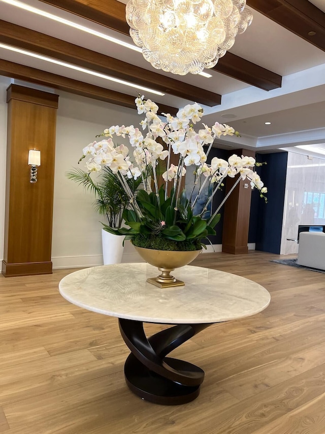 details with hardwood / wood-style floors and a chandelier