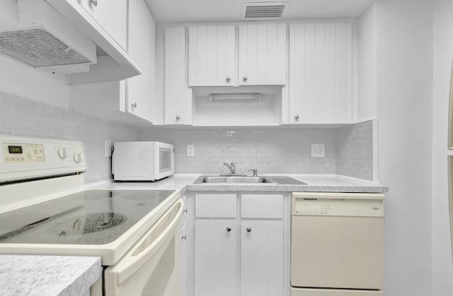 kitchen featuring tasteful backsplash, white appliances, white cabinets, and sink