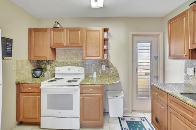 kitchen featuring backsplash, white range with electric stovetop, and light stone counters