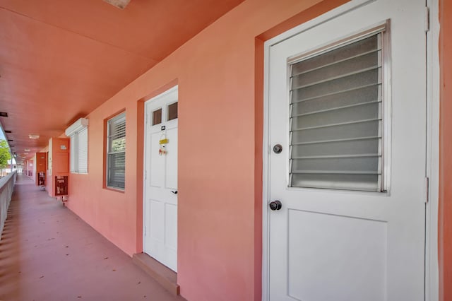 view of exterior entry featuring covered porch