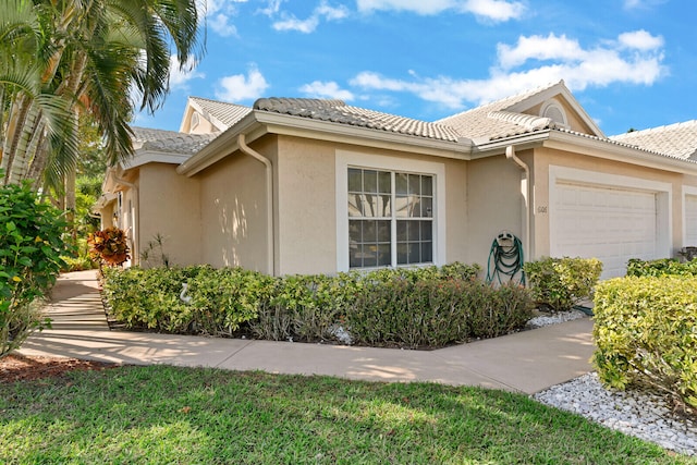 view of side of property with a garage