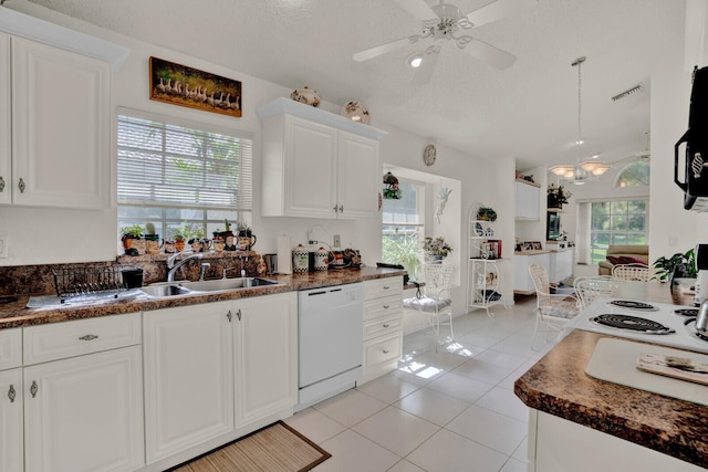 kitchen with white dishwasher, plenty of natural light, white cabinetry, and ceiling fan with notable chandelier