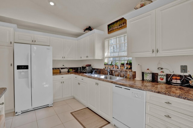 kitchen featuring light tile floors, white appliances, white cabinetry, lofted ceiling, and sink