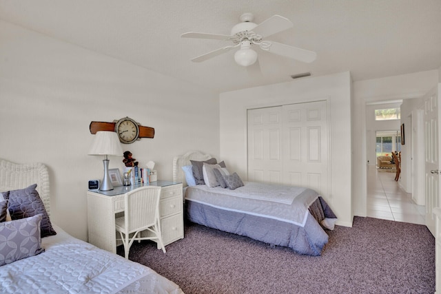 tiled bedroom featuring a closet and ceiling fan