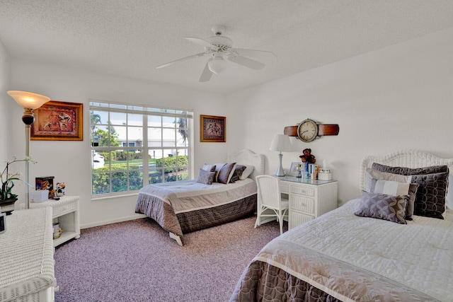 carpeted bedroom with a textured ceiling and ceiling fan