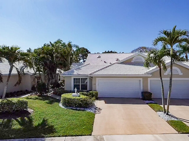 view of front of property with a front yard and a garage