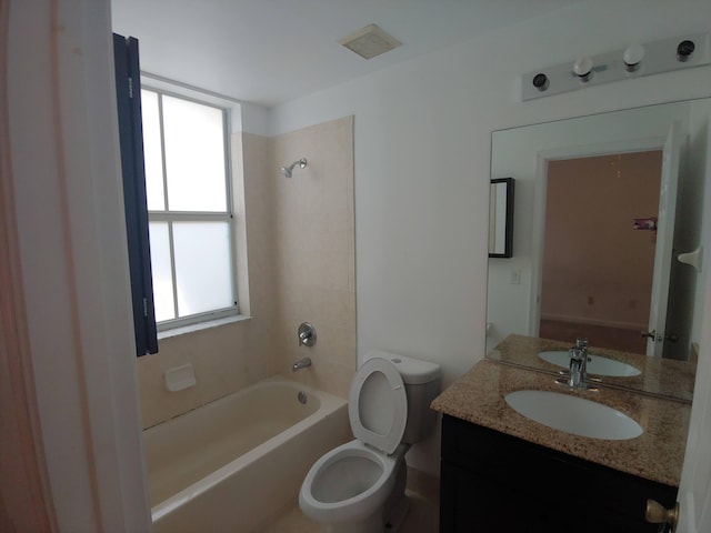 full bathroom with tiled shower / bath, toilet, and vanity