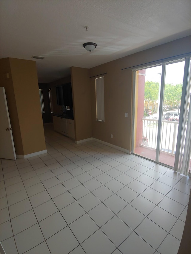 unfurnished room featuring light tile flooring