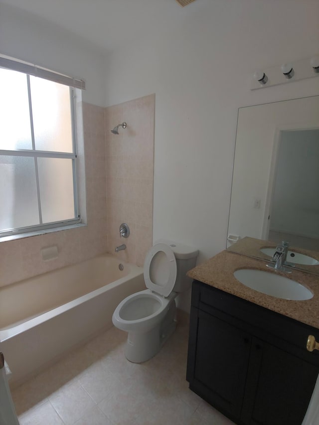 full bathroom featuring tiled shower / bath combo, tile flooring, vanity, and toilet