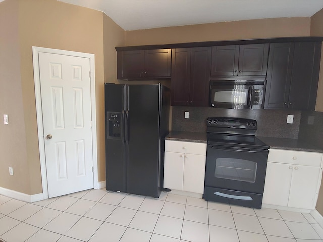 kitchen featuring dark stone countertops, tasteful backsplash, light tile floors, and black appliances