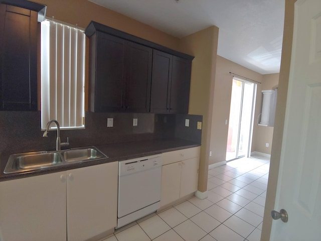 kitchen featuring sink, tasteful backsplash, dishwasher, and light tile floors