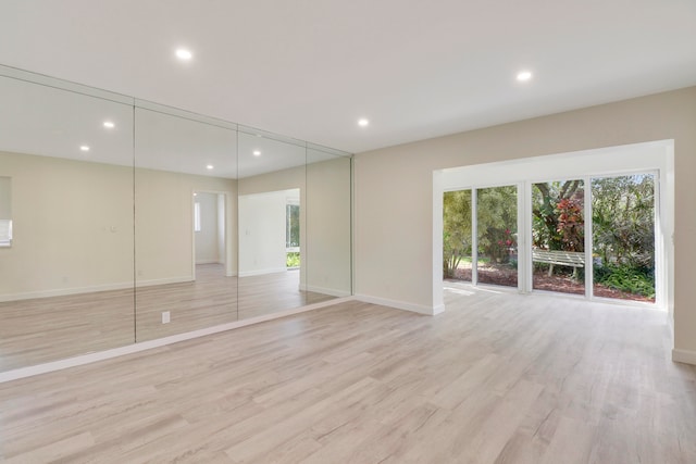 interior space featuring light wood-type flooring, baseboards, and recessed lighting