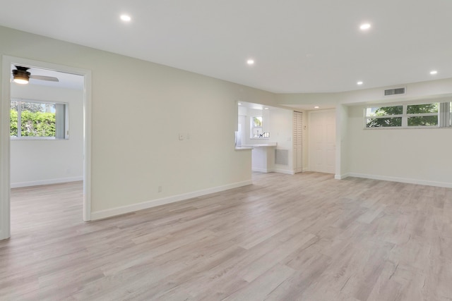 unfurnished living room with light wood-style floors, recessed lighting, and visible vents