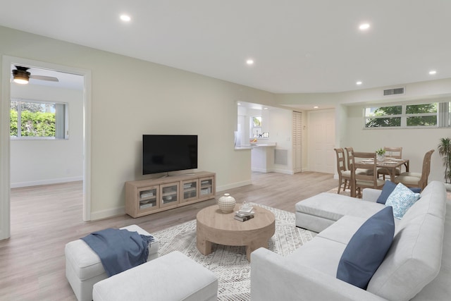 living room featuring recessed lighting, visible vents, light wood-style flooring, and baseboards