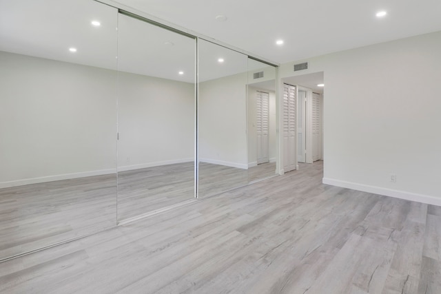 unfurnished bedroom featuring recessed lighting, visible vents, light wood-style flooring, and baseboards