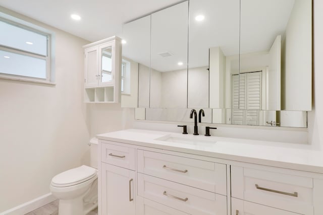 full bath with toilet, recessed lighting, visible vents, vanity, and a closet