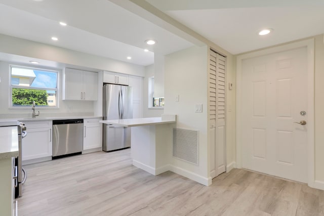 kitchen featuring white cabinets, visible vents, appliances with stainless steel finishes, and light countertops