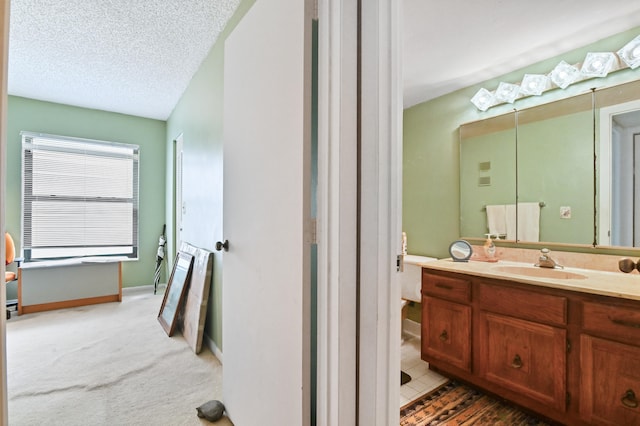 bathroom with vanity and a textured ceiling