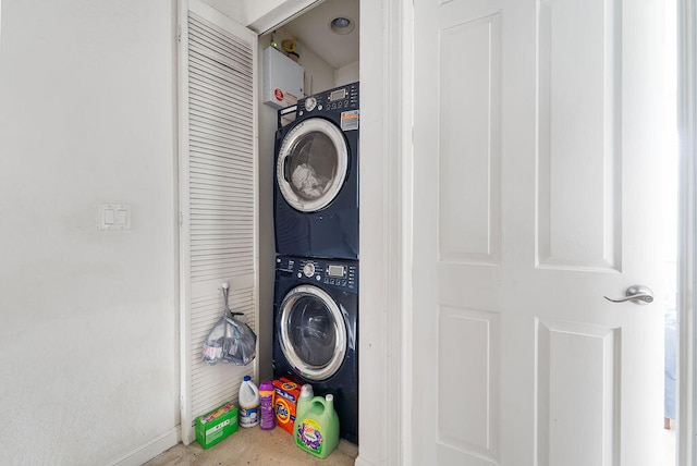 laundry area featuring stacked washer / drying machine