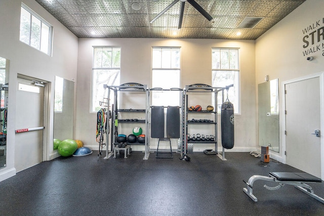 exercise room with a towering ceiling