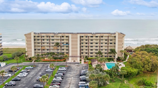 view of property featuring a water view and a community pool