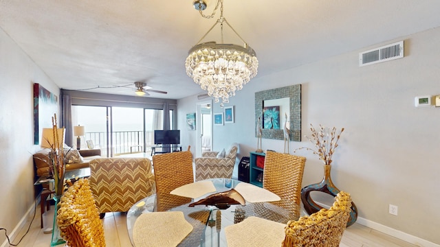 dining room featuring ceiling fan with notable chandelier and light hardwood / wood-style flooring