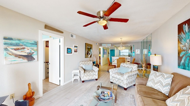 living room with light hardwood / wood-style floors and ceiling fan