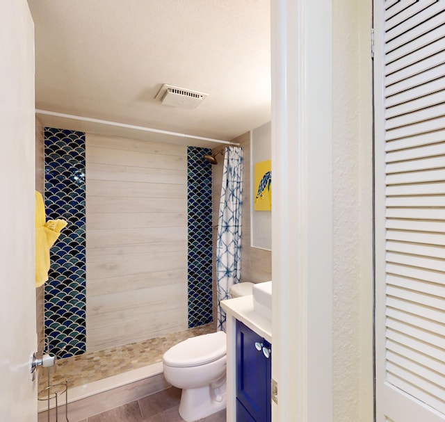 bathroom with vanity, tile flooring, a shower with shower curtain, and toilet