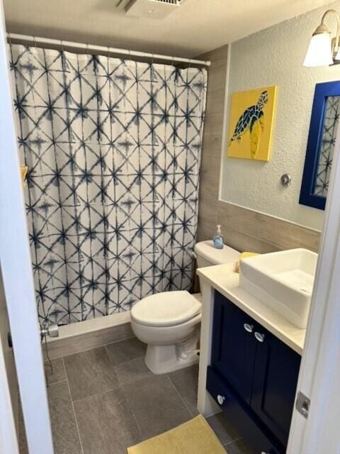 bathroom with vanity, tile flooring, and toilet