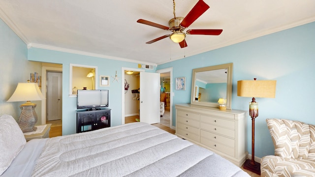 bedroom featuring ornamental molding, ceiling fan, and light wood-type flooring