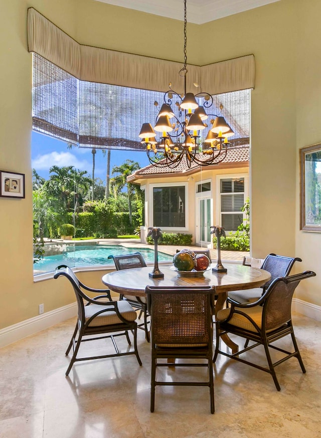 dining area featuring a towering ceiling, light tile floors, and a chandelier