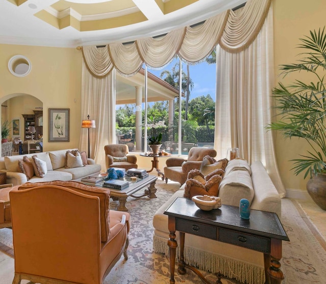 living room featuring crown molding and coffered ceiling