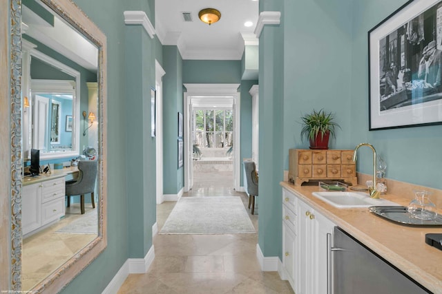 bathroom with ornamental molding, vanity, and tile floors